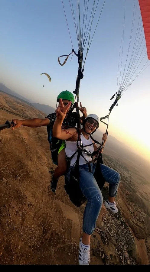 Two passengers flying above the valley