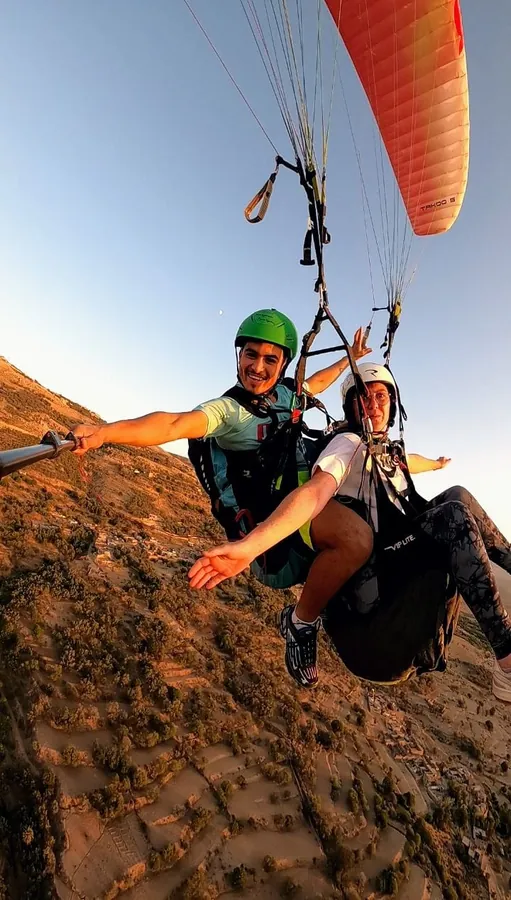 Pilot and passenger above the ridge at sunset